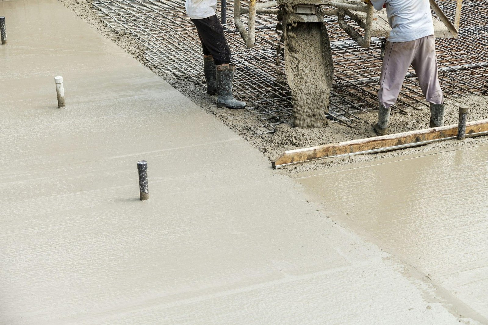 Pouring concrete into the construction of the house. Builders are pouring ready-mixed concrete